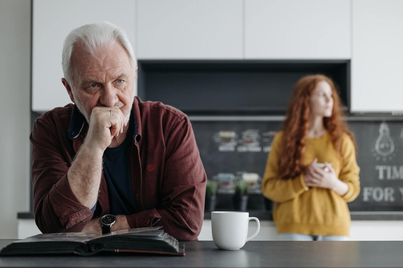 man looking worried whilst drinking coffee